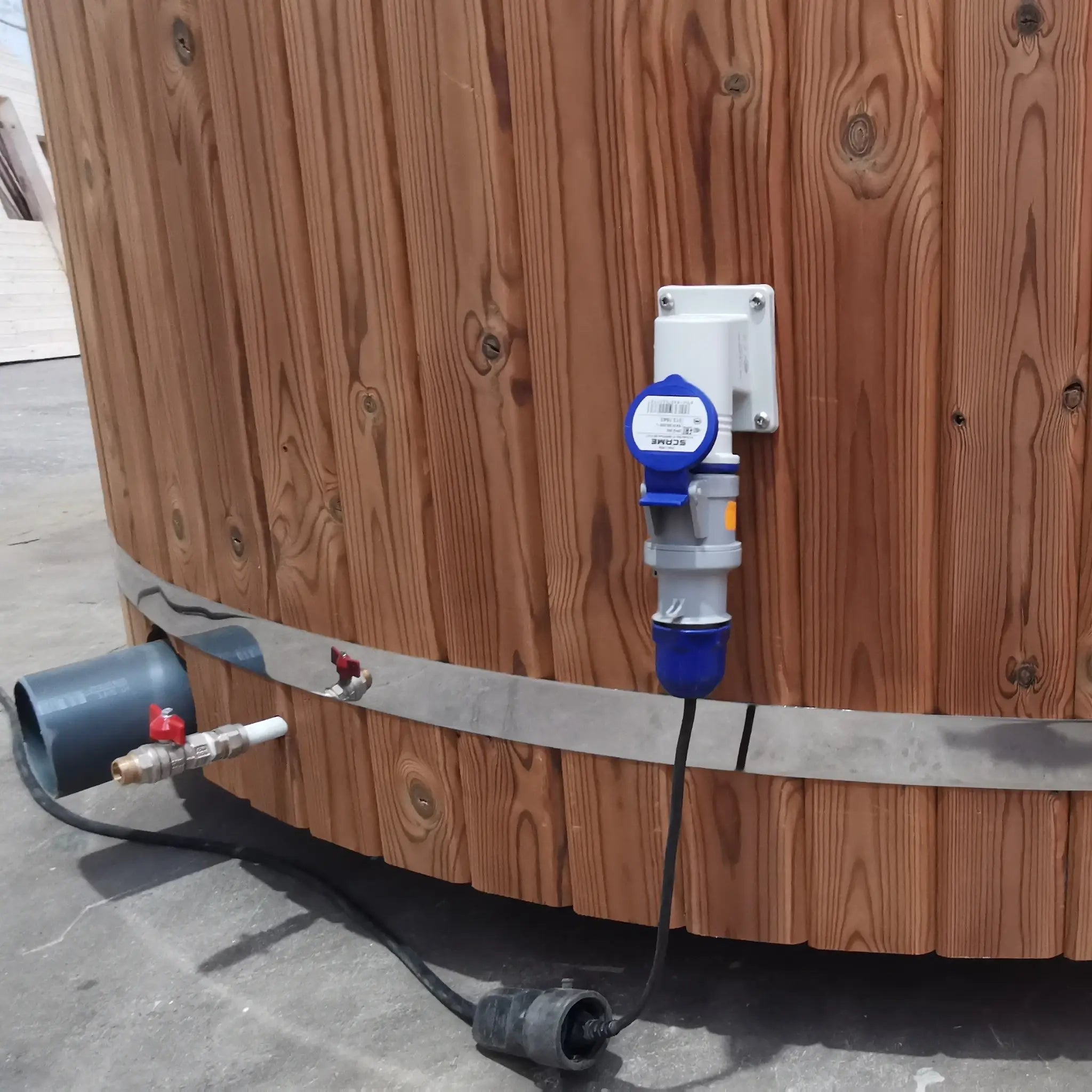 Close-up of external commando power socket mounted on the timber-clad exterior of The Washwood Barrel.