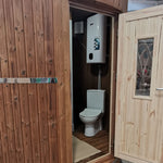 Washwood Barrel interior showing compact WC and hot water system through open door