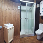 Full interior bathroom view of the Washwood Barrel with sink, shower, and toilet