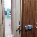 Interior view of Washwood Barrel entrance with power sockets and timber lining