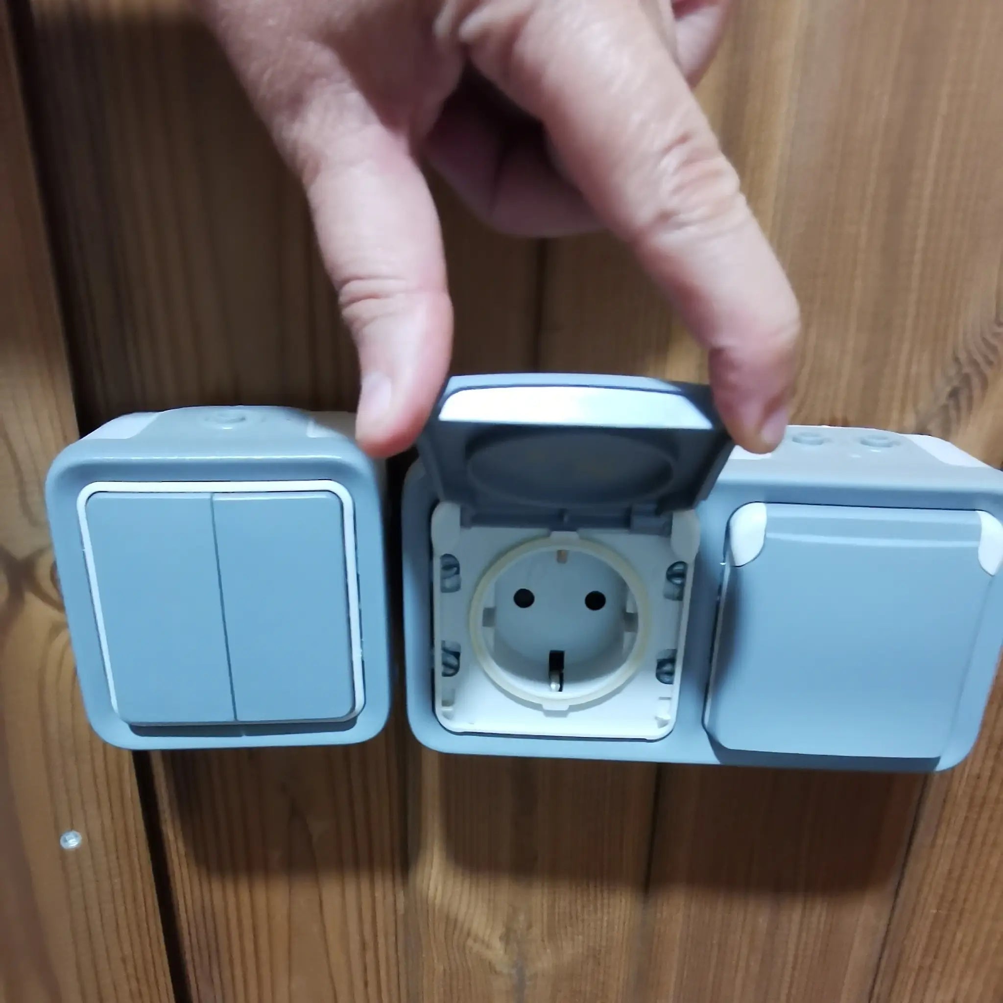 Weatherproof electrical socket with protective cover inside the Washwood Barrel bathroom