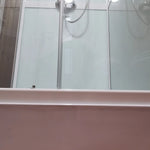 Close-up of shower base and drainage in Washwood Barrel bathroom