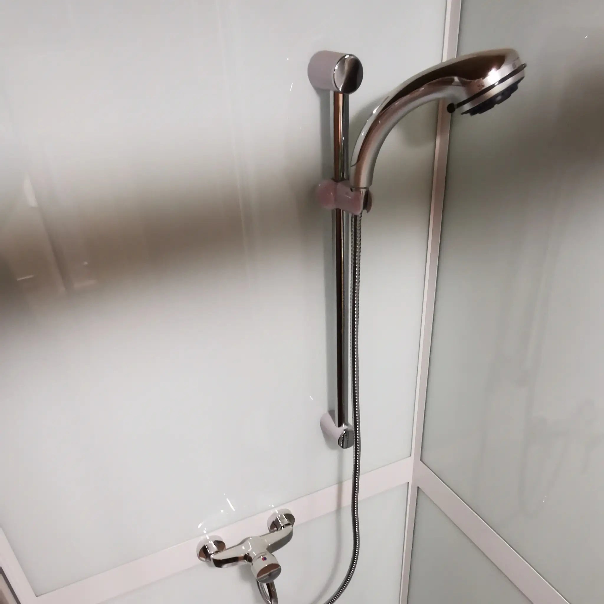 Chrome shower rail and mixer tap inside the Washwood Barrel shower cubicle