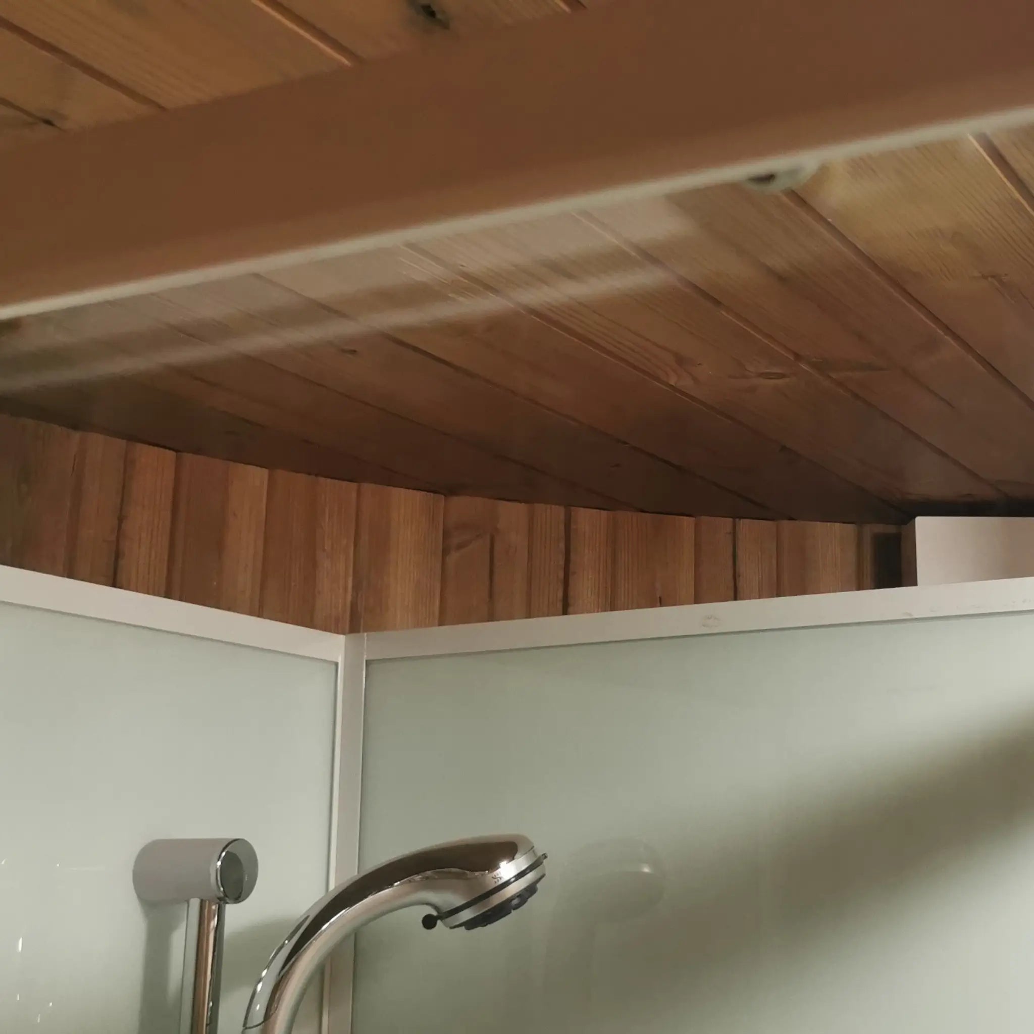 Timber-lined ceiling detail above the shower area in the Washwood Barrel bathroom