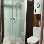 Close-up of shower base and drainage in Washwood Barrel bathroom