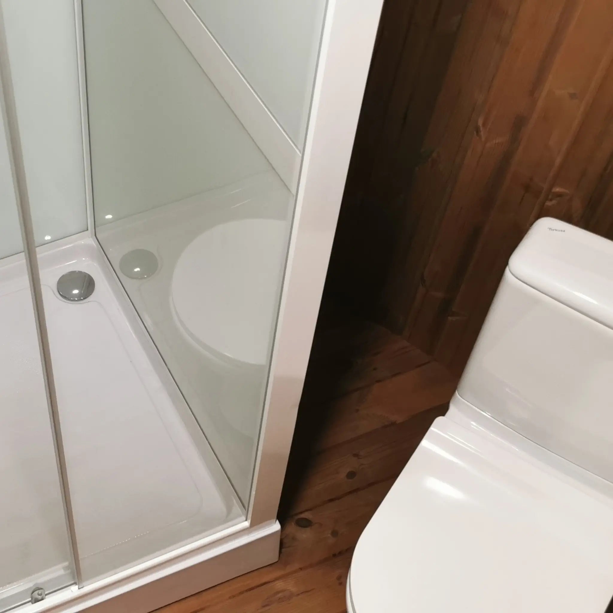 Compact shower and toilet configuration in Washwood Barrel interior