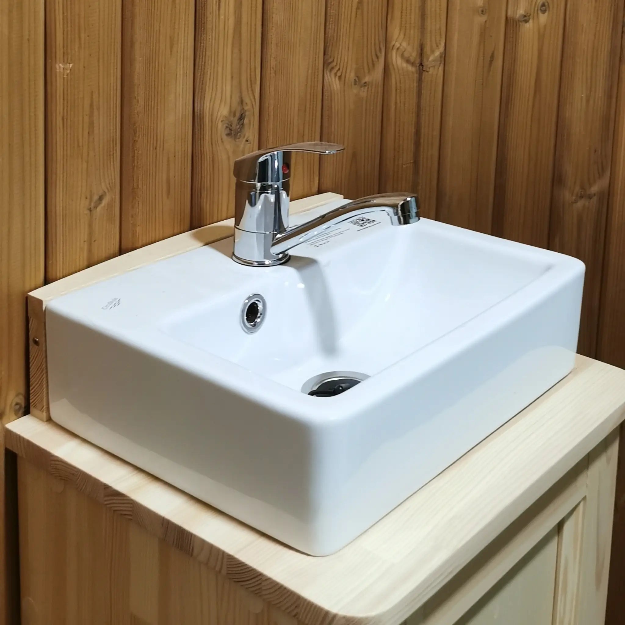 Close-up of ceramic basin and chrome tap inside the Washwood Barrel