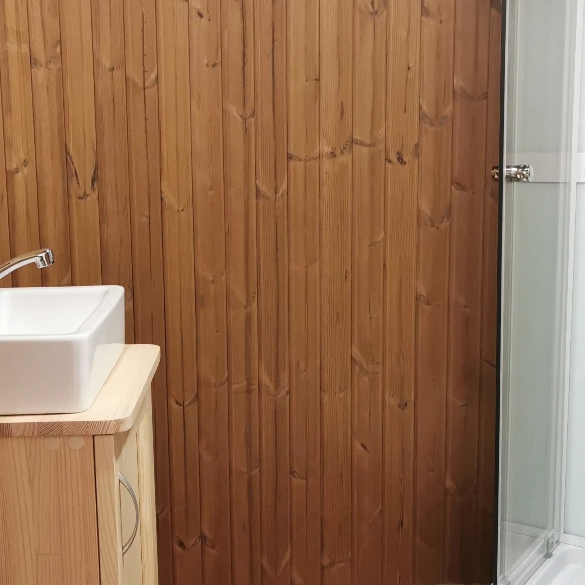 Timber-clad bathroom wall with vanity unit and shower enclosure in the Washwood Barrel