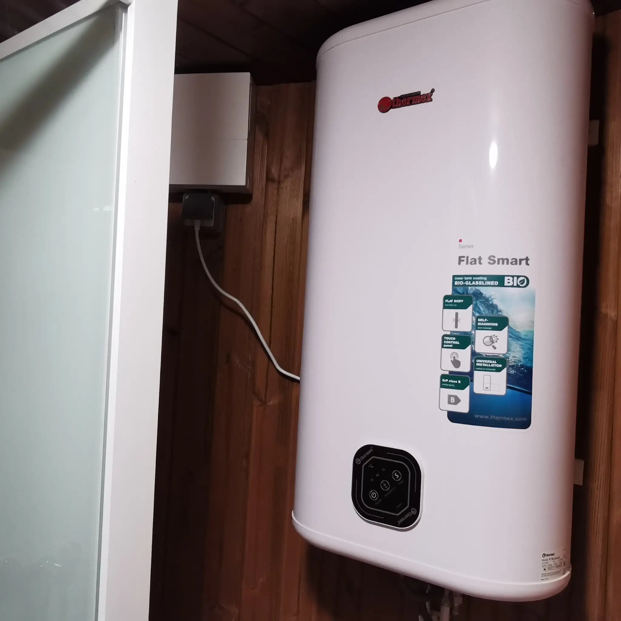 Close-up of electric water heater mounted inside the Washwood Barrel bathroom