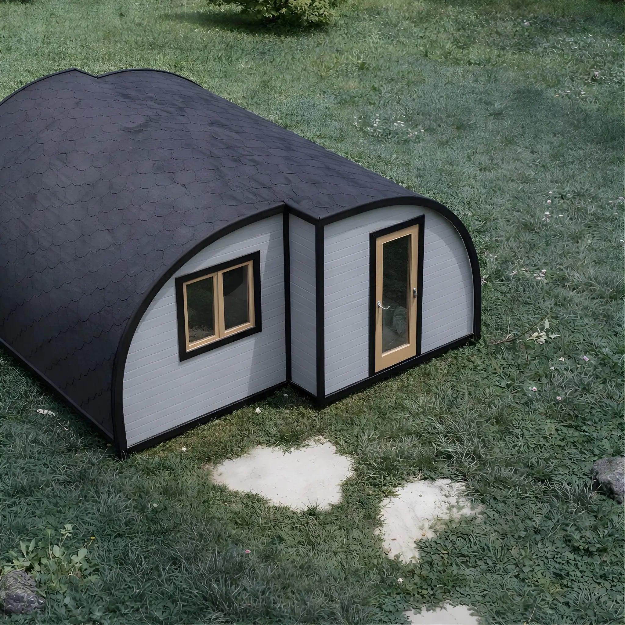 Aerial view of the Dual Halfmoon Pod luxury 2 person glamping pod with curved roof design, timber-framed windows and insulated exterior, set within a natural countryside setting.