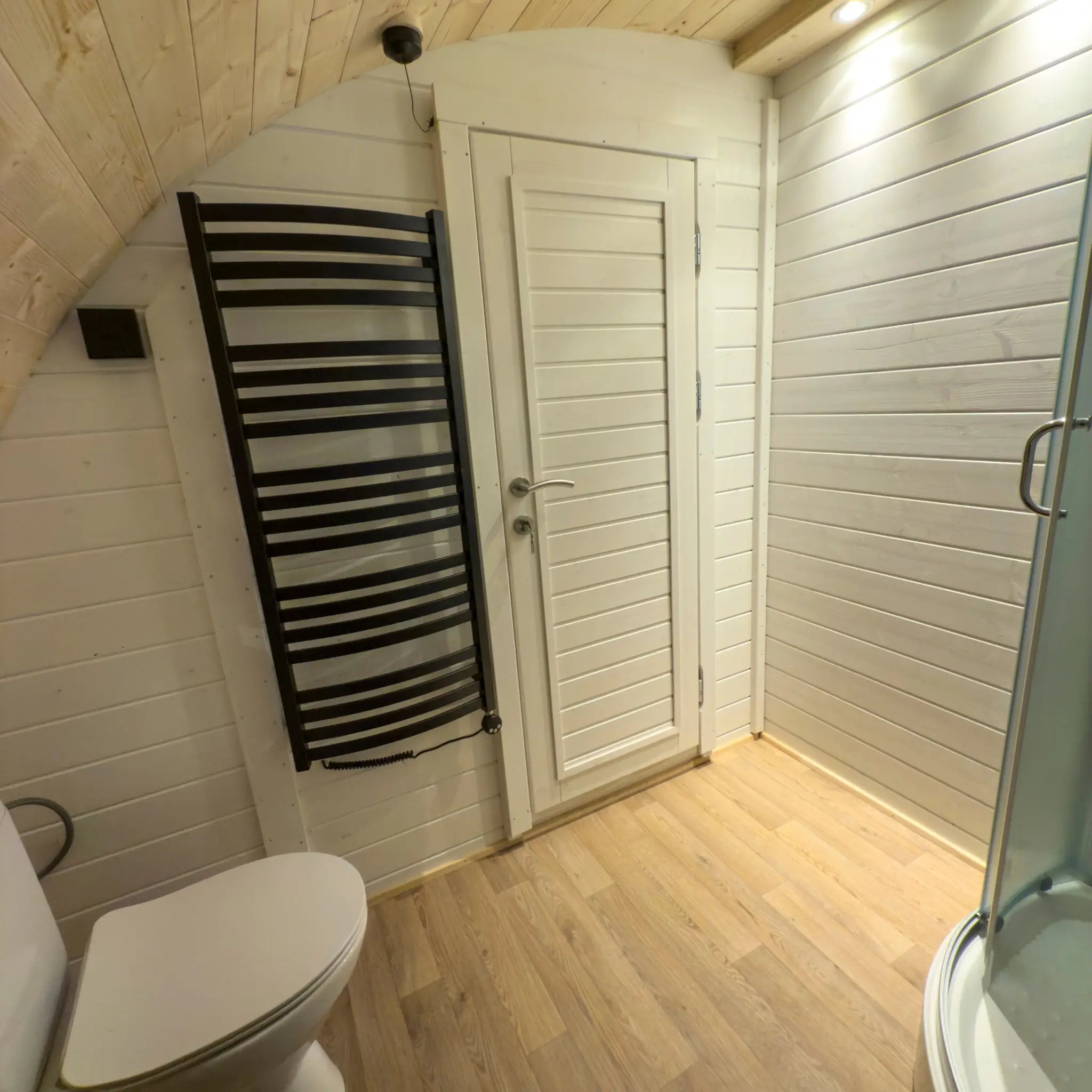Toilet and electric towel radiator in ensuite bathroom of Dual Halfmoon pod