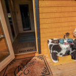 Welcoming entrance to The Dual Halfmoon luxury 4 person glamping pod featuring covered porch, timber cladding and glazed entrance door