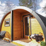 Right exterior view of The Dual Halfmoon luxury 4 person glamping pod with glazed entrance, curved roof and timber exterior