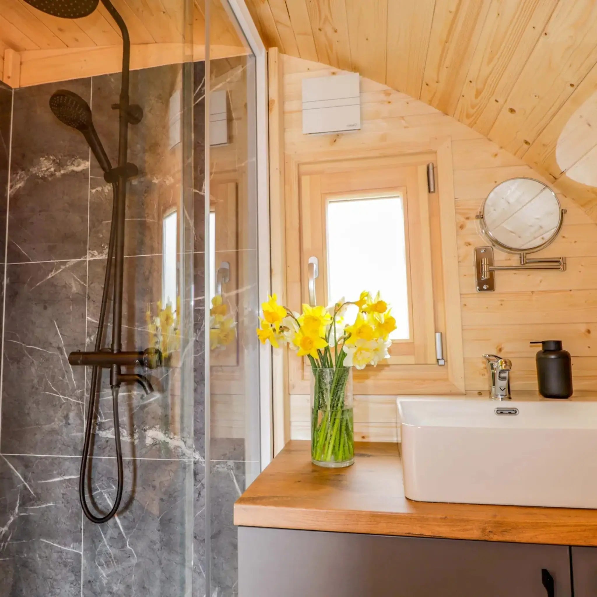 Luxury bathroom vanity and shower inside The Dual Halfmoon luxury 4 person glamping pod with contemporary finishes