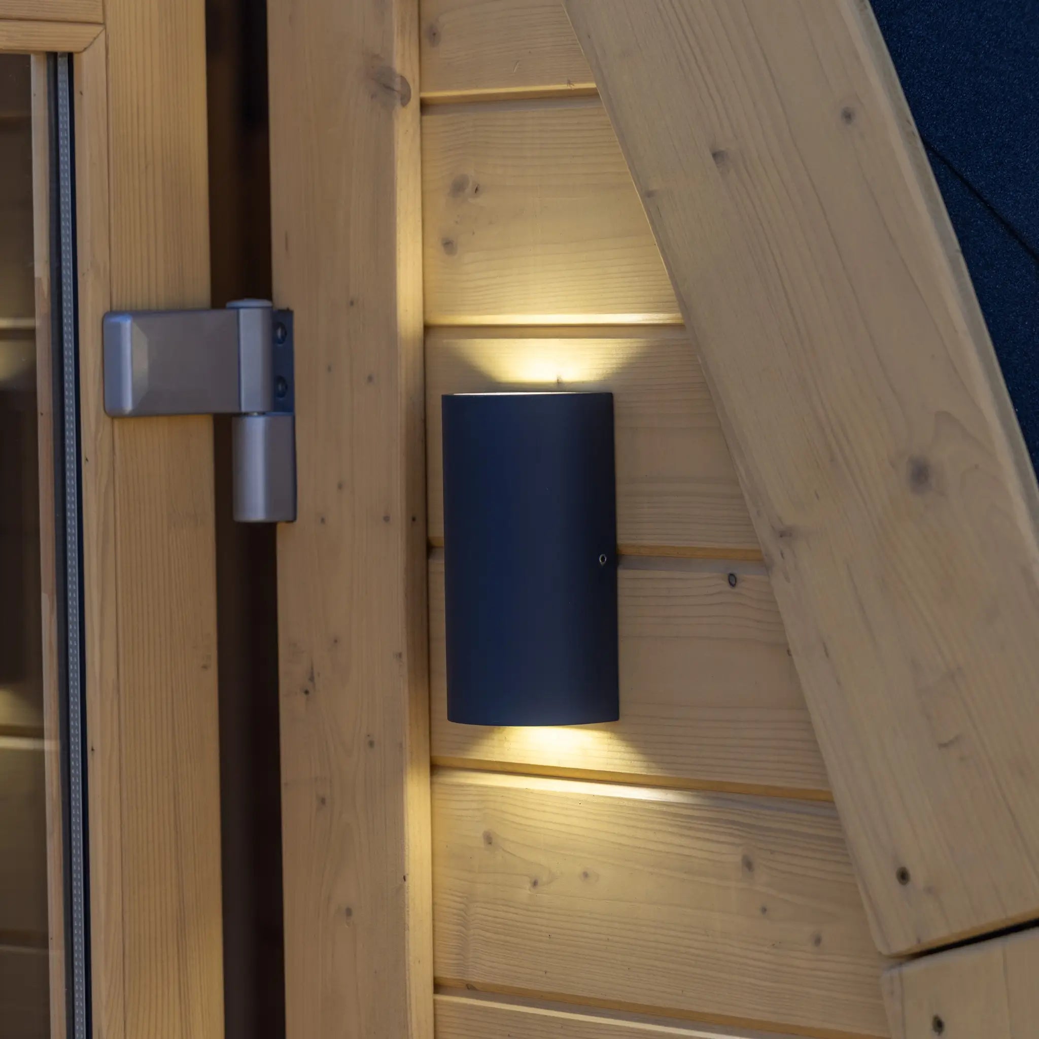 Exterior wall light detail on Hobbit garden office pod showing modern outdoor lighting on natural timber cladding