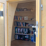 Close-up of open double doors on Hobbit garden pod entrance highlighting solid wood frame and glazed panels
