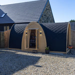 Full exterior side view of Hobbit garden office pod with arched structure, black shingle roof and modern backyard setting