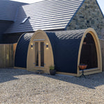 Hobbit pod side angle with full glass end wall offering panoramic countryside views and modern garden office design