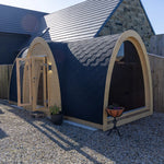 Angled exterior view of Hobbit garden office pod with curved roof, timber frame and large glass feature wall