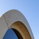 Close-up of curved timber arch detail on Hobbit garden pod highlighting craftsmanship and natural wood finish