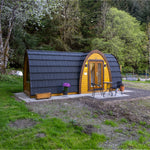 Front elevation of luxury timber glamping pod with glazed entrance doors