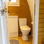 Ensuite bathroom with toilet and vanity unit inside luxury glamping pod