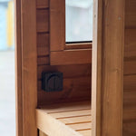 Changing room bench with light switch inside the Infinity Glass luxury barrel sauna