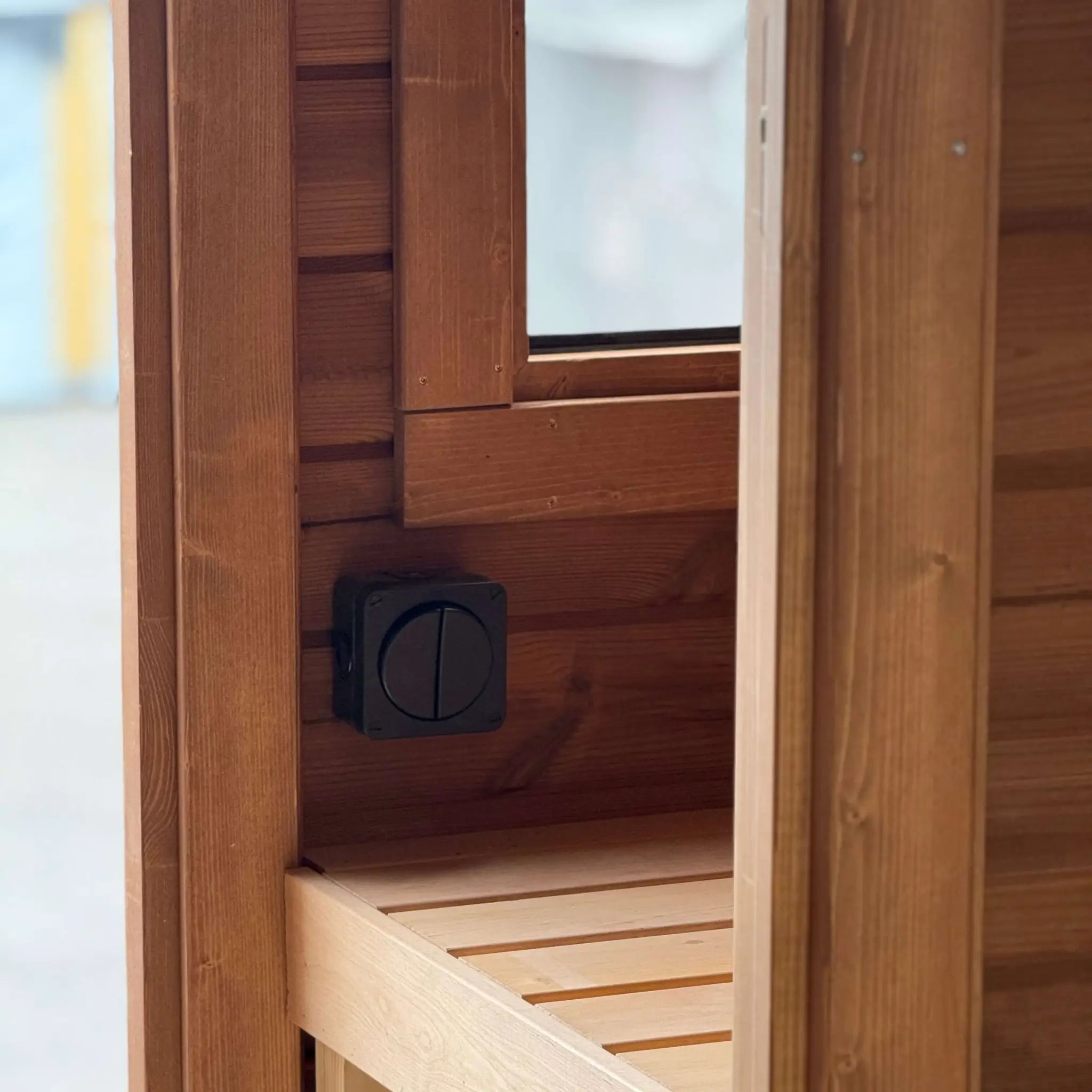 Changing room bench with light switch inside the Infinity Glass luxury barrel sauna