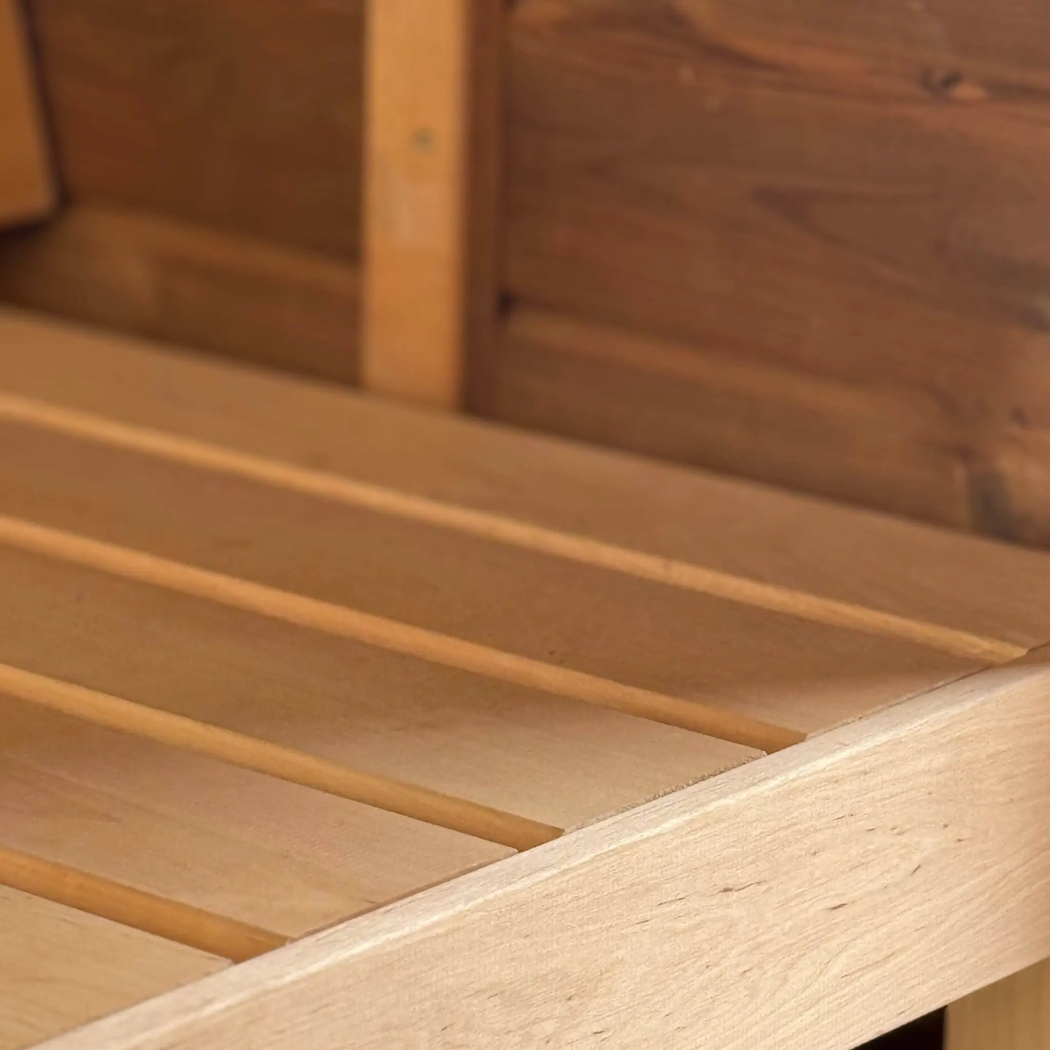 Close-up of premium alder sauna bench seating inside the Infinity Glass luxury barrel sauna