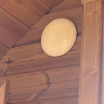 Timber sauna wall light providing warm ambient illumination inside the Infinity Glass barrel sauna