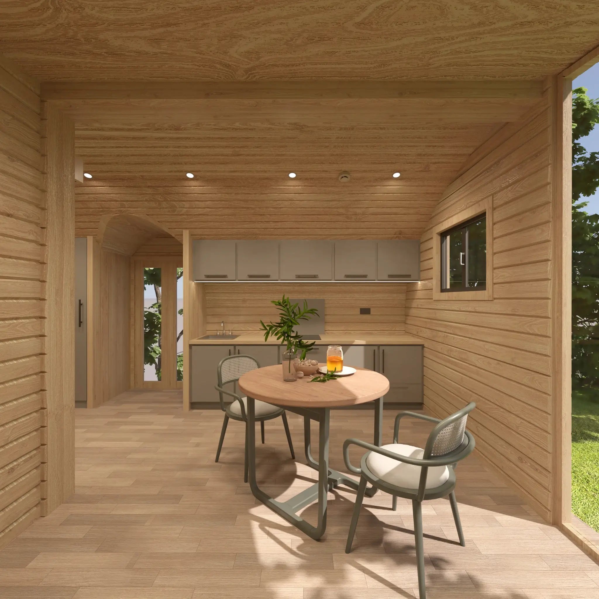 Modern kitchen and dining space within the Moonburrow Pod luxury glamping accommodation, designed with natural wood finishes and space-efficient layout.
