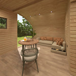 Open-plan living room and dining table inside the Moonburrow Pod, a luxury 2-person glamping pod with curved wooden walls and contemporary furnishings.