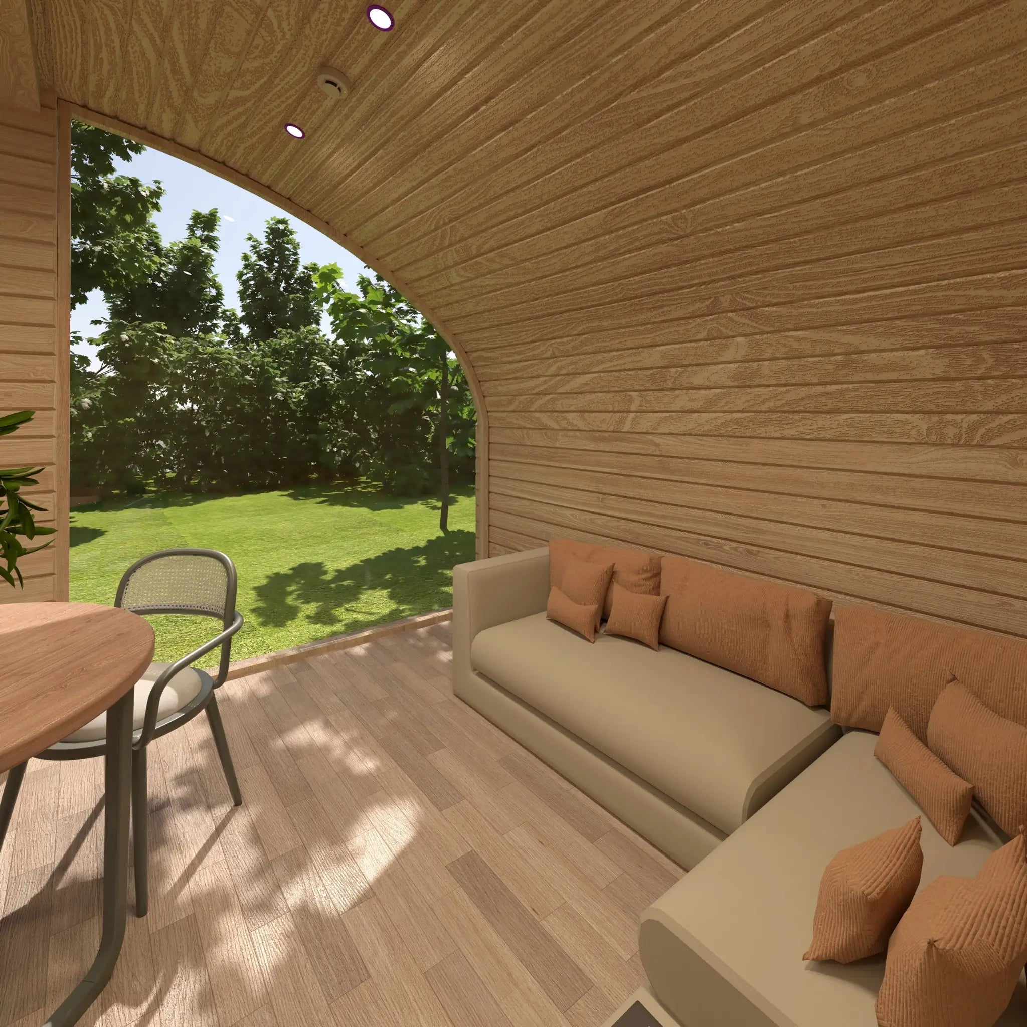 Living room area of the Moonburrow Pod luxury glamping pod, with comfortable seating positioned beside a panoramic window and woodland views.