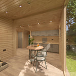 Open-plan interior of the Moonburrow Pod luxury glamping accommodation, showcasing the seamless flow between kitchen, dining, and living areas.