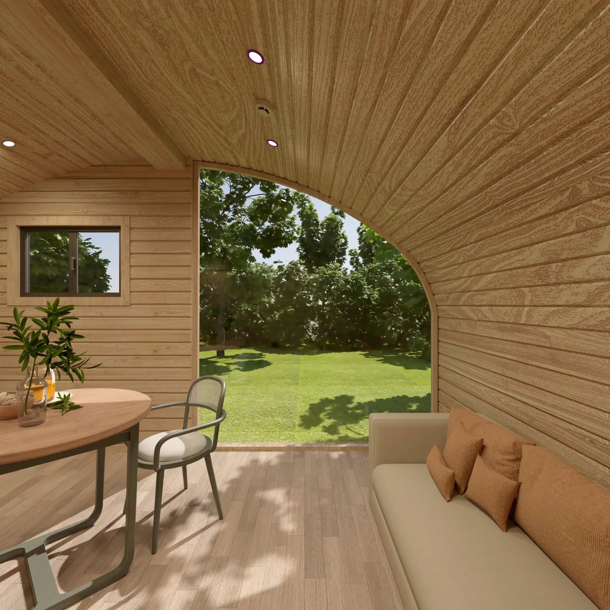 Sofa and dining table area inside the Moonburrow Pod luxury 2-person glamping pod, designed to maximise natural light and panoramic outdoor views.