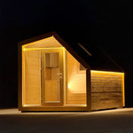 Angled night-time view of The Ridgefall Pod 2 person glamping pod, highlighting its pitched roof, timber exterior, and ambient LED lighting.