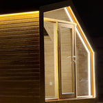 Close-up of the front entrance on The Ridgefall Pod 2 person glamping pod, featuring glazed timber doors and warm LED perimeter lighting.