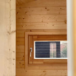 Interior view of The Ridgefall Pod showing a rear window that brings natural light into the 2 person glamping space.