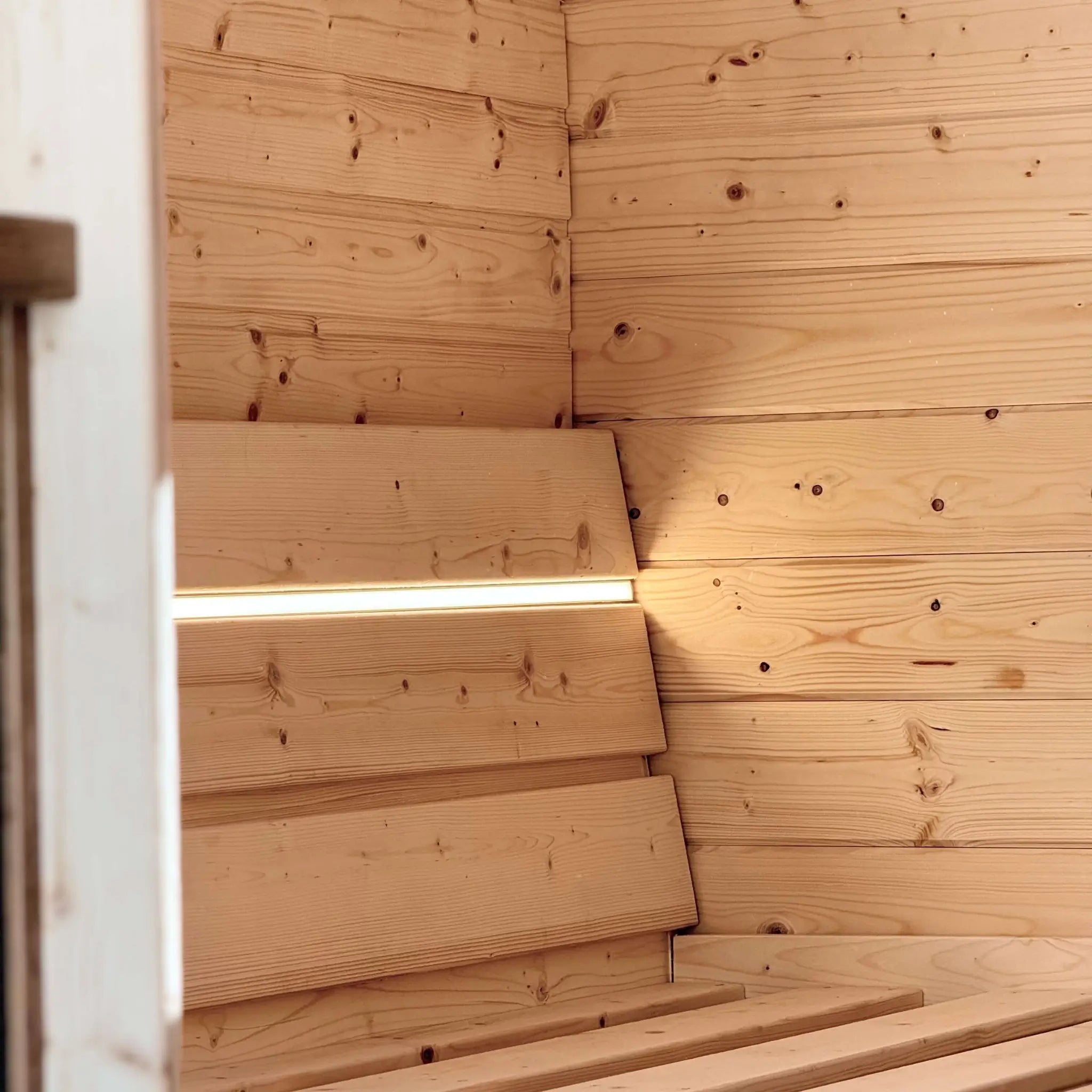 Double bed frame inside The Ridgefall Pod with integrated LED lighting, combining comfort and modern glamping design.