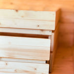 Interior detail of The Ridgefall Pod showing built-in storage drawers beneath the double bed for efficient use of space.