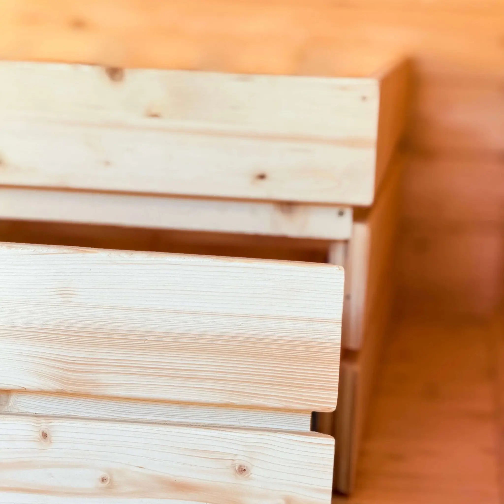 Interior detail of The Ridgefall Pod showing built-in storage drawers beneath the double bed for efficient use of space.