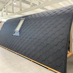 Side exterior view of The Twilight Pod luxury 2 person glamping pod featuring curved roof design and integrated VELUX roof window