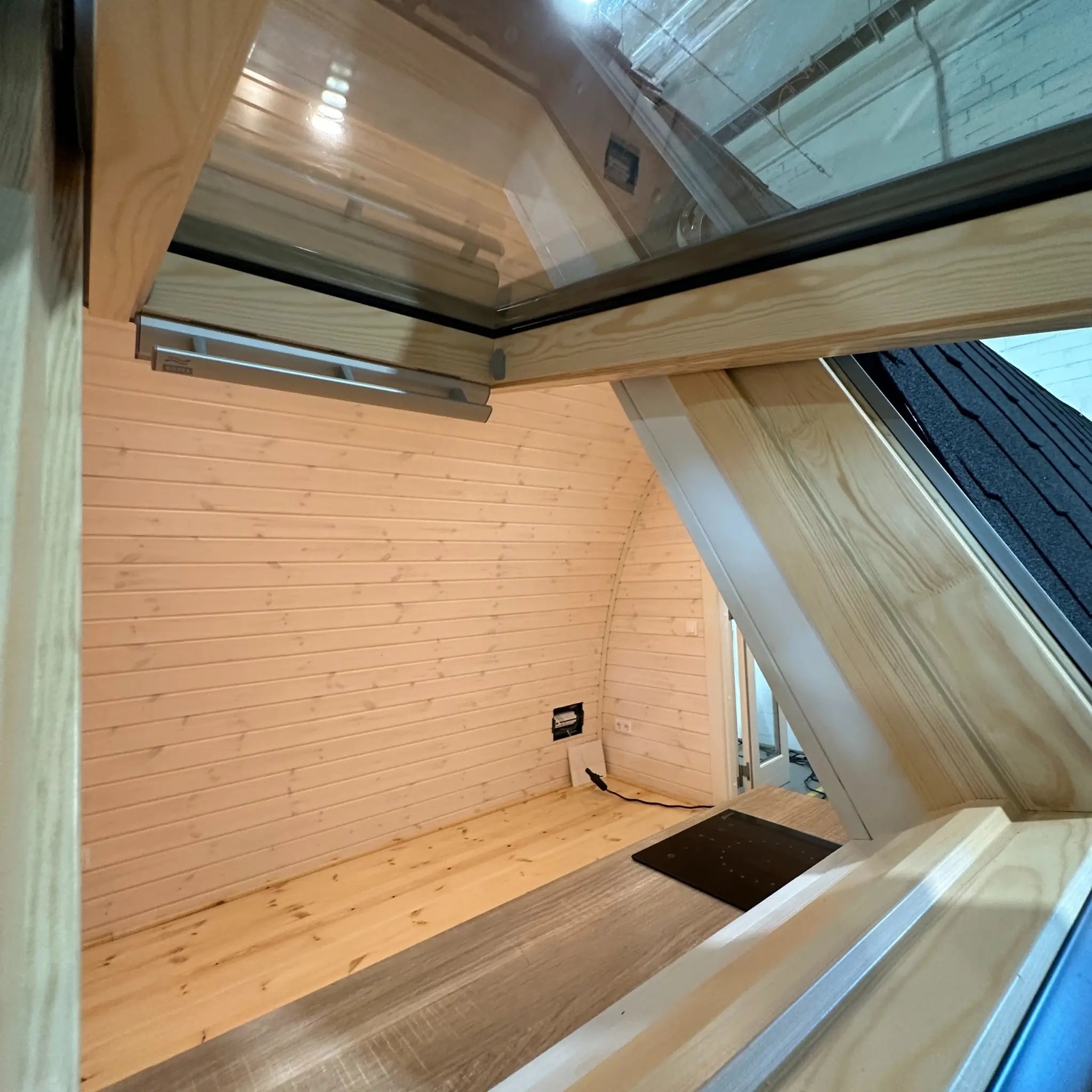 Interior perspective from the VELUX window highlighting the open-plan layout inside The Twilight Pod glamping pod