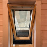 Close-up interior shot of the VELUX roof window frame inside the Twilight Pod with timber cladding details