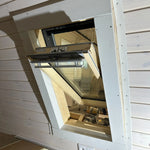 Side view of opened VELUX roof window bringing natural light into the Twilight glamping pod interior