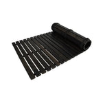 Black treated alder wooden floor mat for sauna and bathroom shown partly rolled