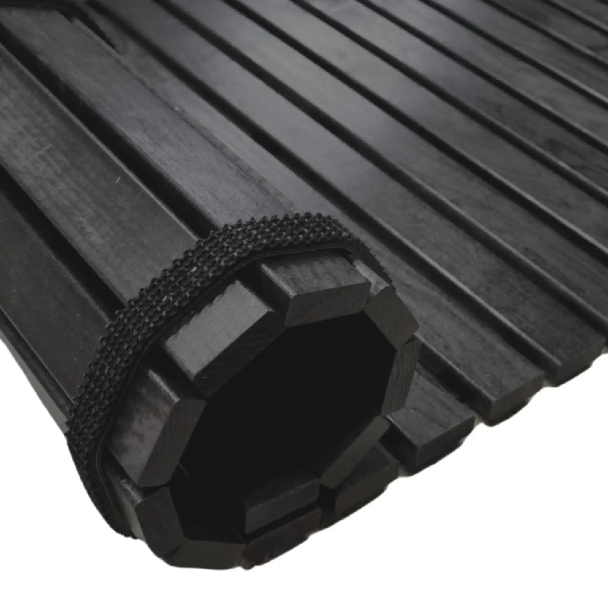 Close-up of black treated alder roll-up wooden floor mat with dark slats and strap