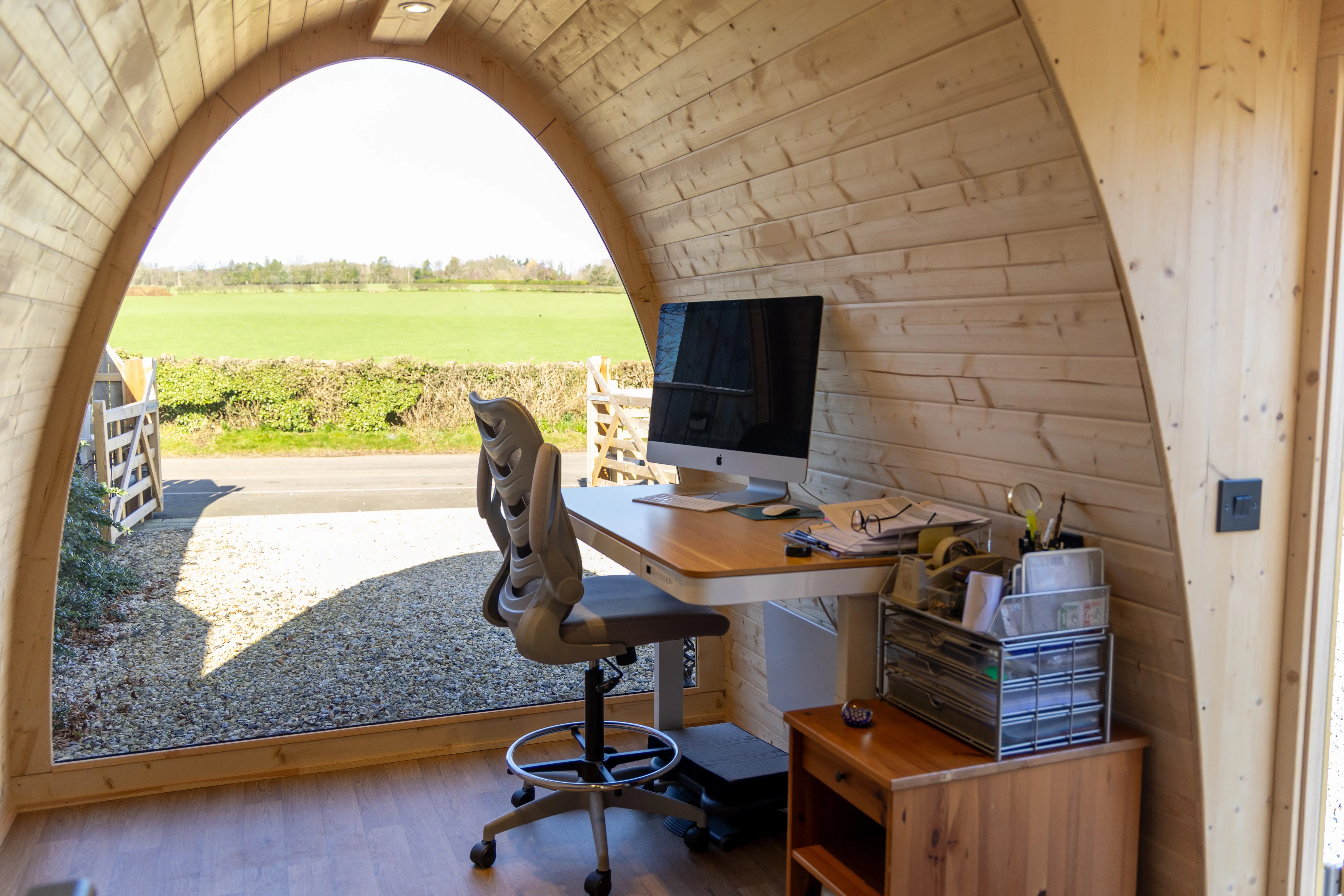 Luxury bespoke garden office pod designed, supplied, and delivered by GlampLaunch, featuring a panoramic glazed front, premium timber interior, ergonomic workspace, and uninterrupted countryside views for productive remote working and home business use.