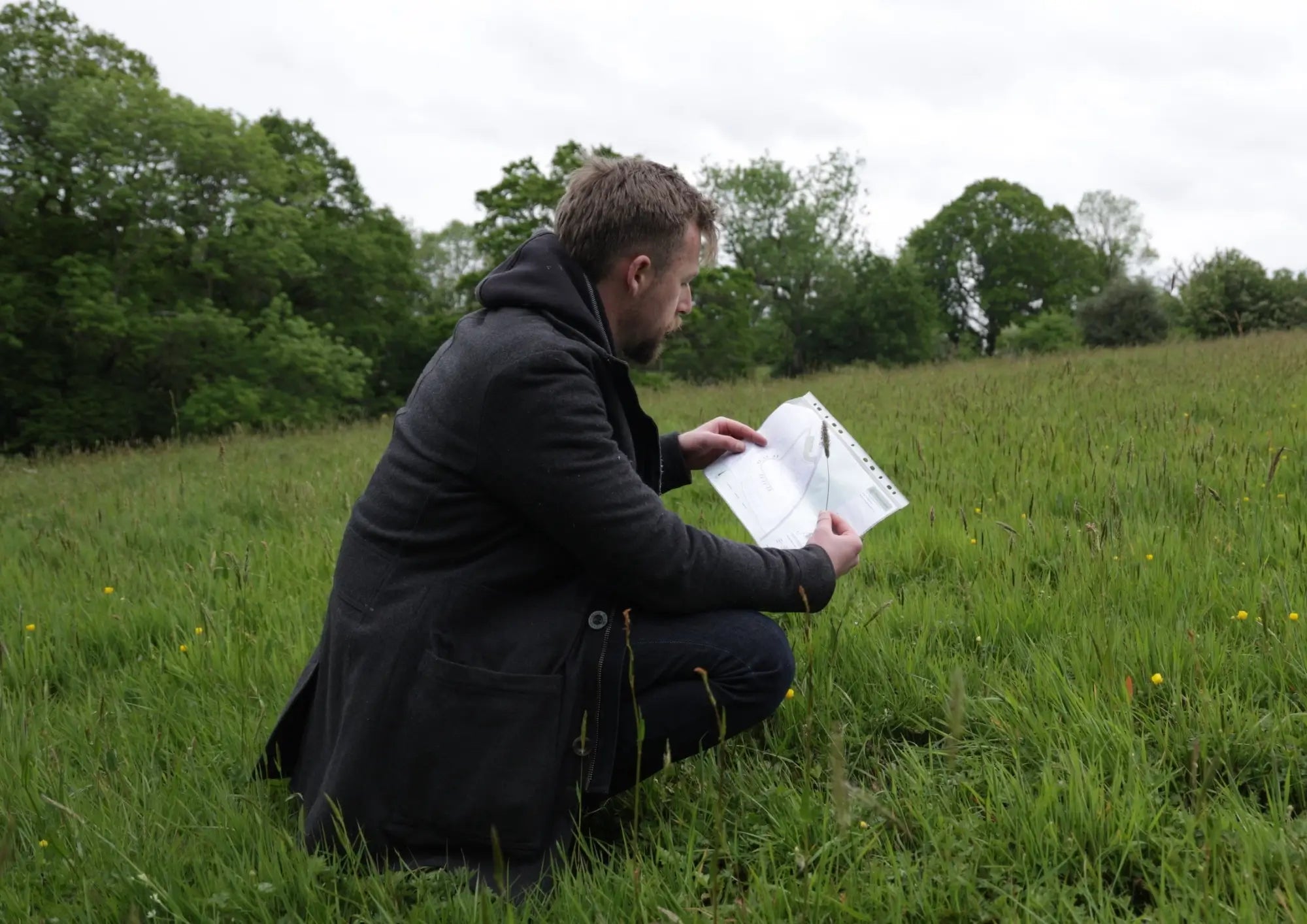 Taylor Glass assessing site plans during a feasibility study for the West Riddens glamping development. The project includes planning support, utility coordination, infrastructure design, hospitality accommodation layout, and the delivery of a 12-unit glamping and tourism development.