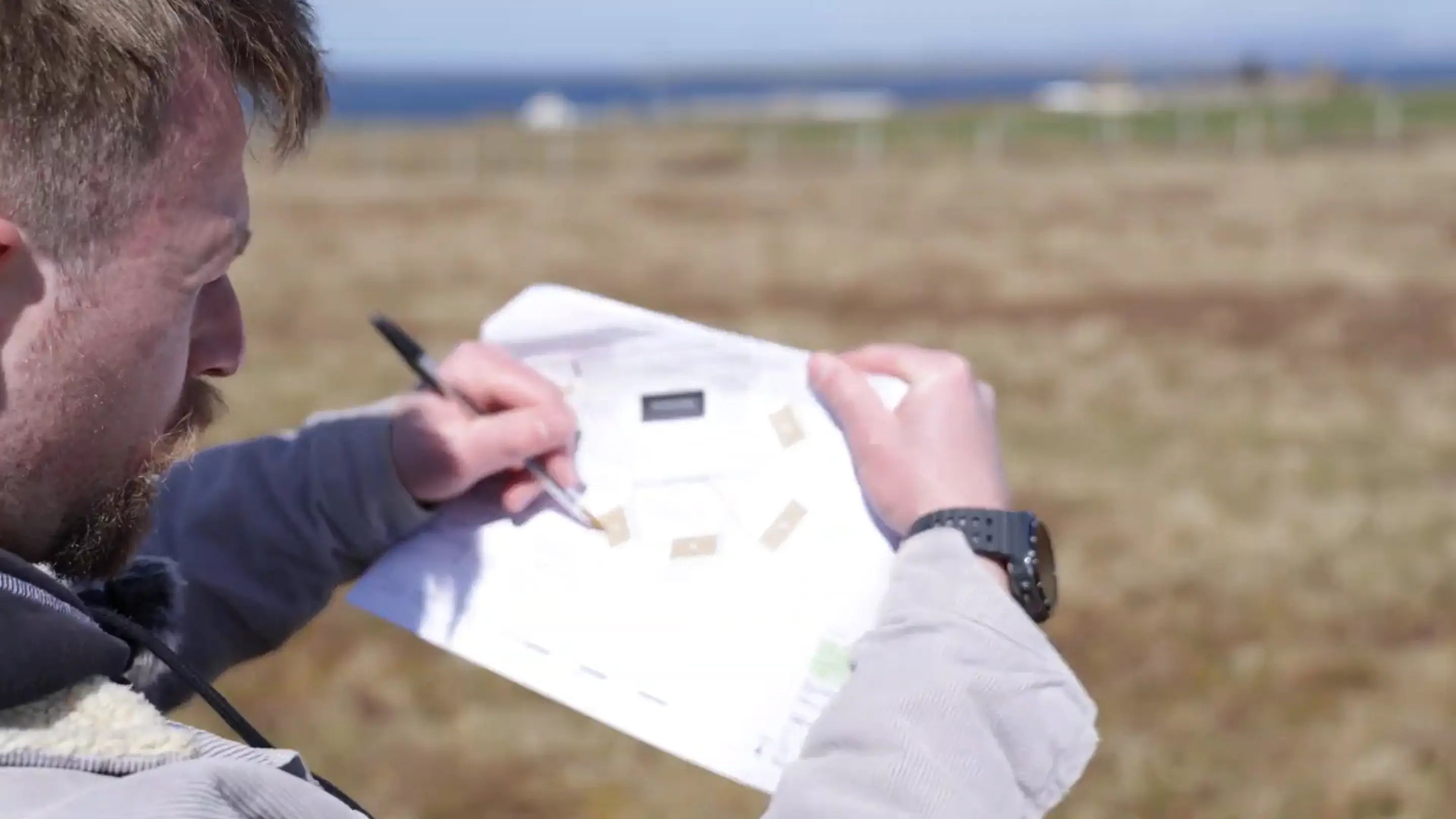GlampLaunch founder reviewing a glamping site layout and project plans on location, helping coordinate planning permission, contractors, utilities, pod installation, and site development from concept through to launch.